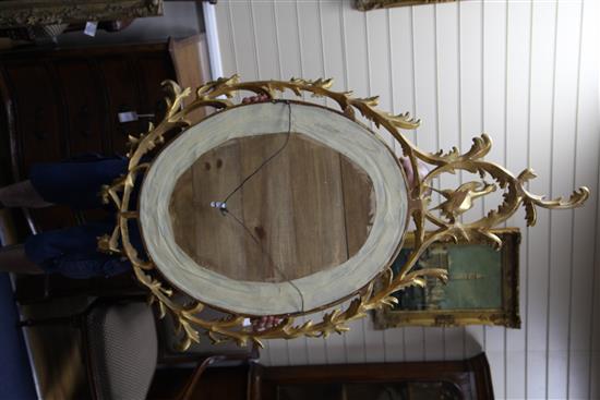 A Victorian oval gilt wall mirror, 4ft 11in. x 2ft 9.5in.